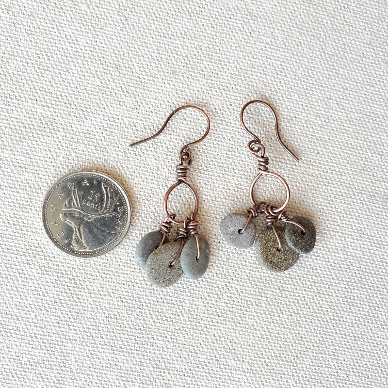 Pair of earrings with gray beads on a white background