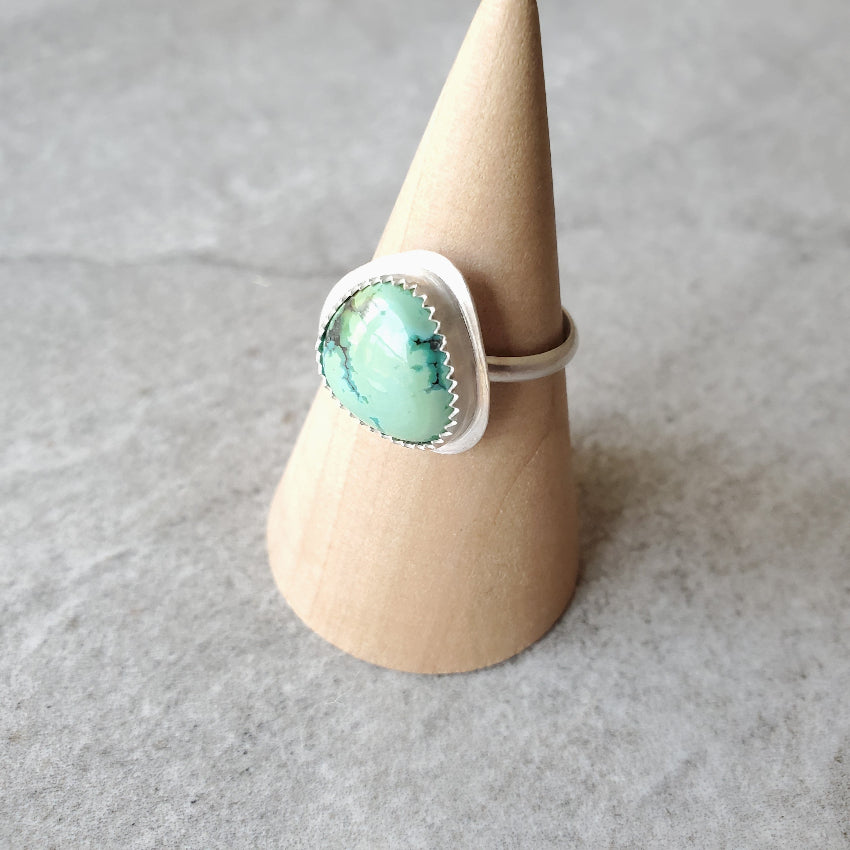 Tibetan Turquoise silversmith ring on wood stand