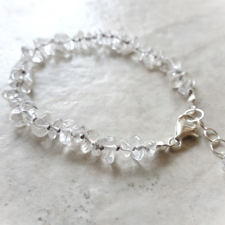 Clear quartz crystal hand knotted bracelet on tile 