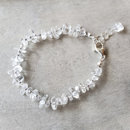 Clear quartz crystal hand knotted bracelet on wood