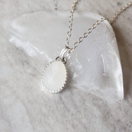 faceted white moonstone pendant on ice