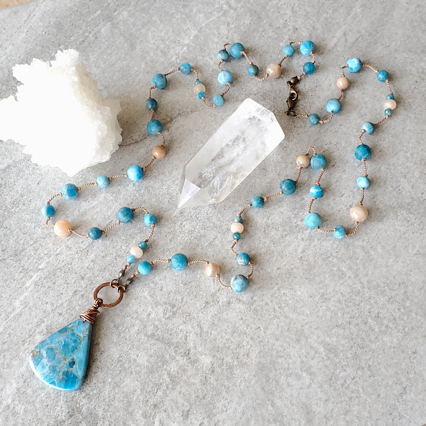 Blue Apatite and Sunstone Knotted necklace on tile
