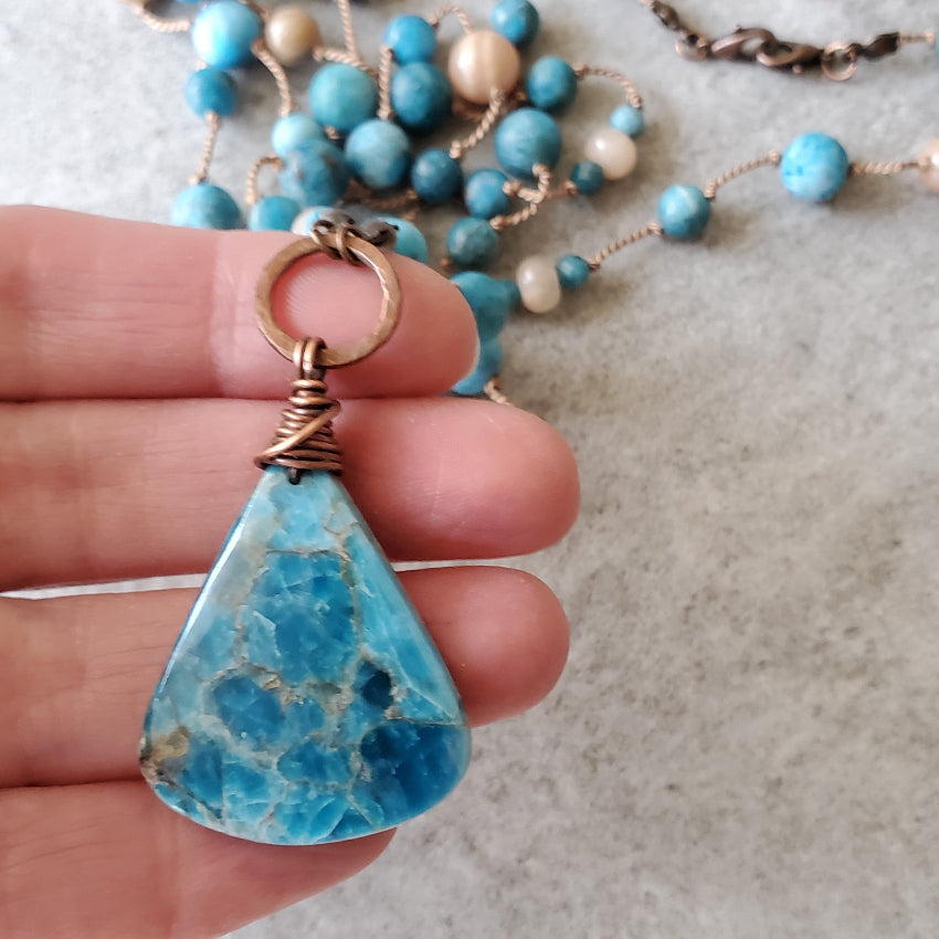 Blue Apatite and Sunstone Knotted necklace in hand