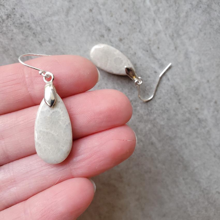 Fossil coral teardrop sterling silver earrings in hand
