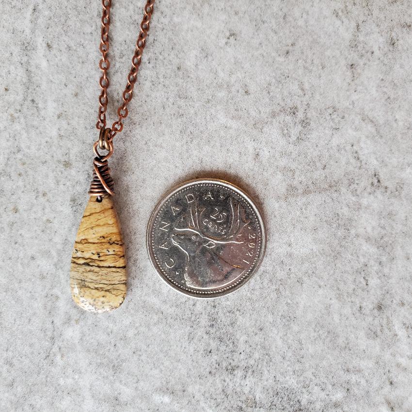 picture jasper teardrop pendant copper necklace beside a quarter