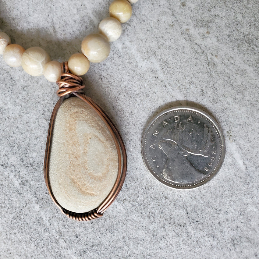 Beach rock focal stone beside a quarter