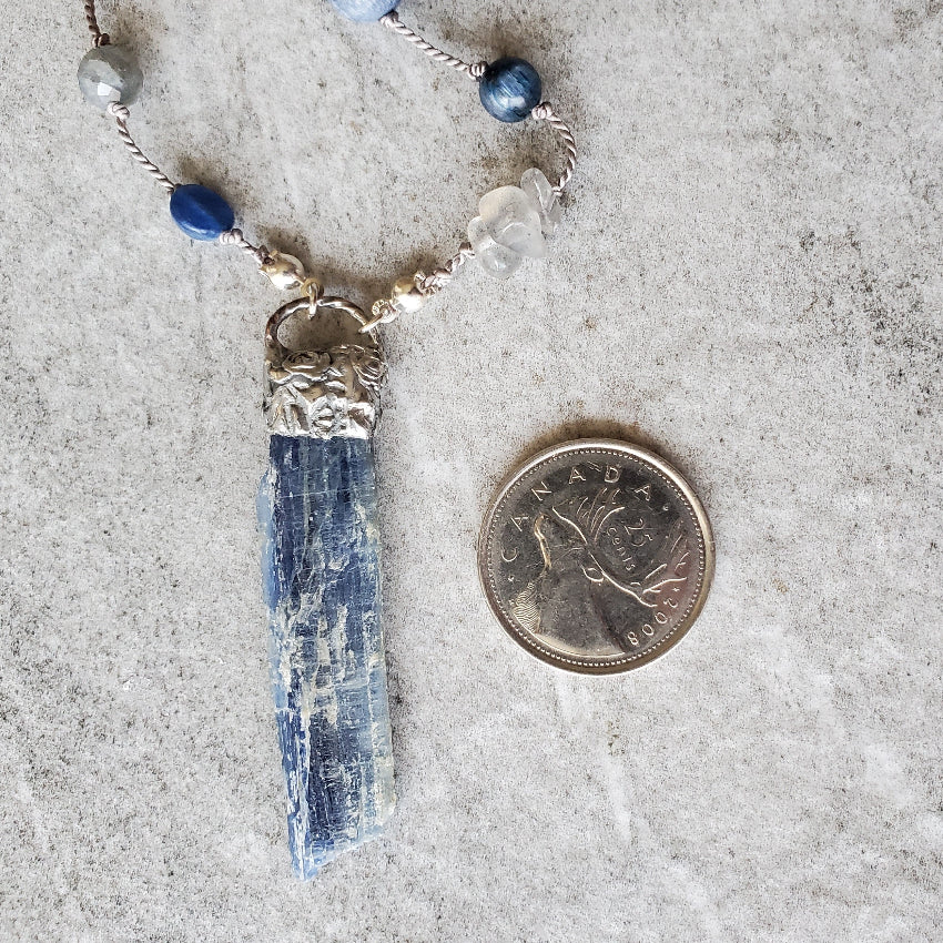 Blue Kyanite focal beside a quarter