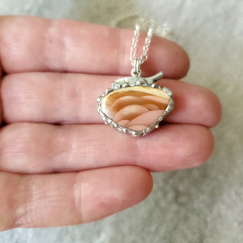 Freeform Imperial Jasper soft solder style pendant in hand