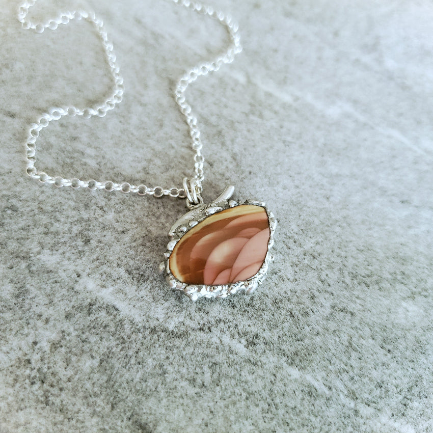 Imperial Jasper soft solder style pendant on a textured surface