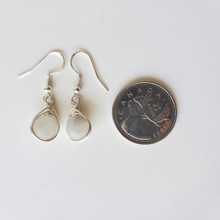 Frosted Smoky Quartz herringbone wrapped earrings beside a quarter