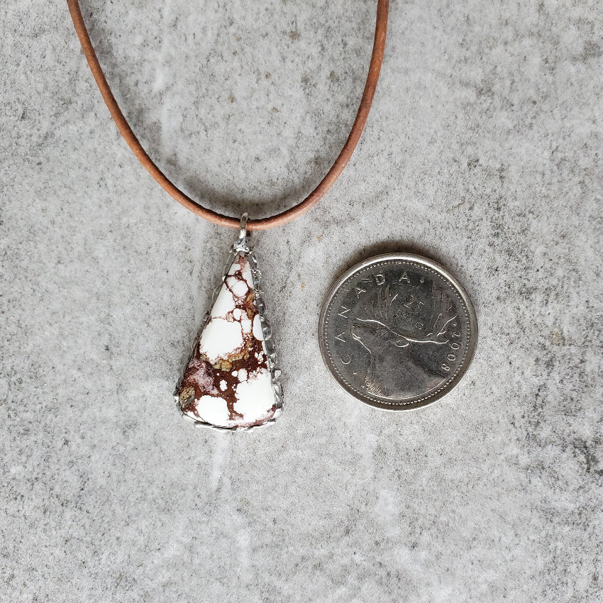 Wild Horse magnesite necklace beside a quarter