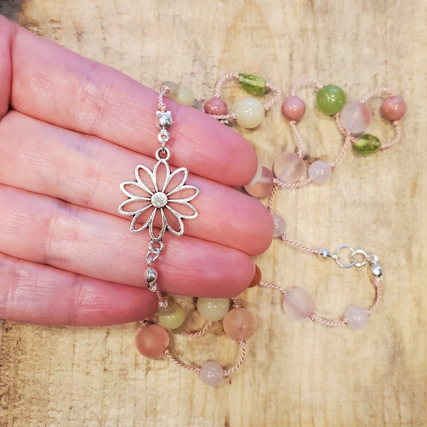 Colourful silk knotted necklace with multi gemstones and a flower connector.