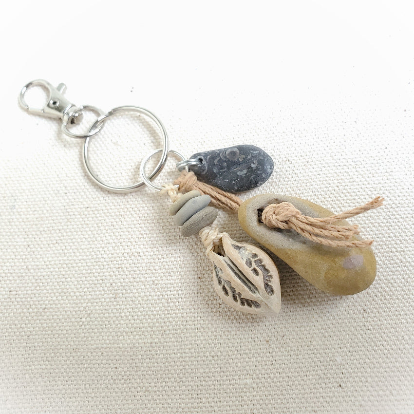 Keychain with natural elements on a beige fabric background