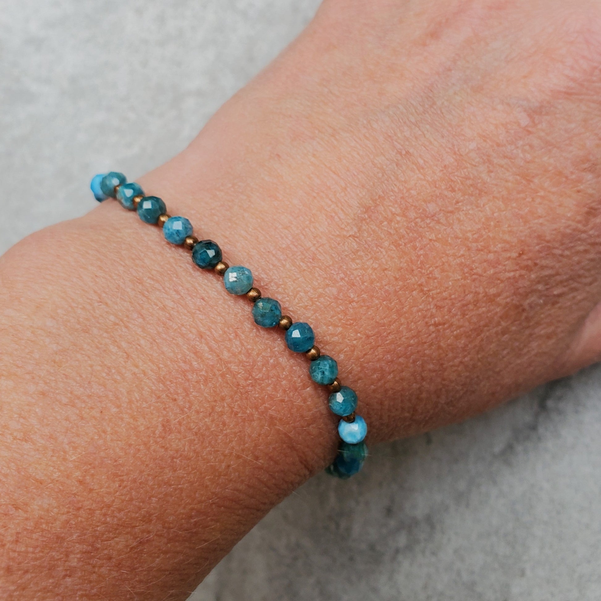 Diamond cut faceted Blue Apatite bracelet with copper accents on model