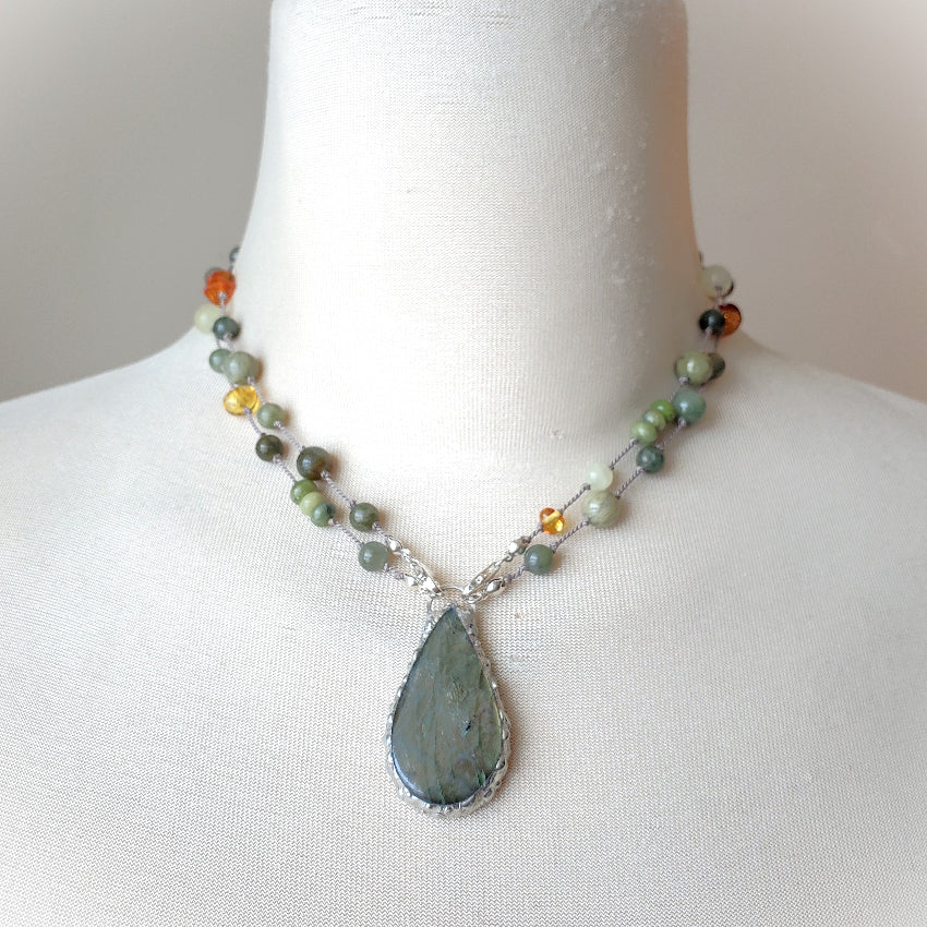 Necklace with a teardrop pendant on a mannequin