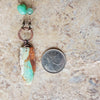 Chrysoprase focal multi gemstone knotted necklace beside a quarter