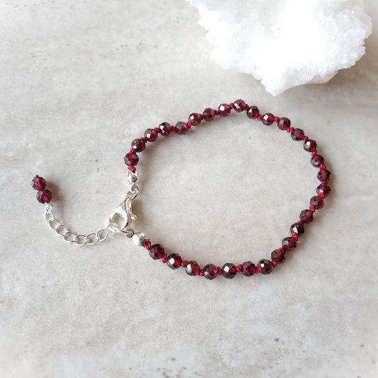 Garnet knotted bracelet on tile