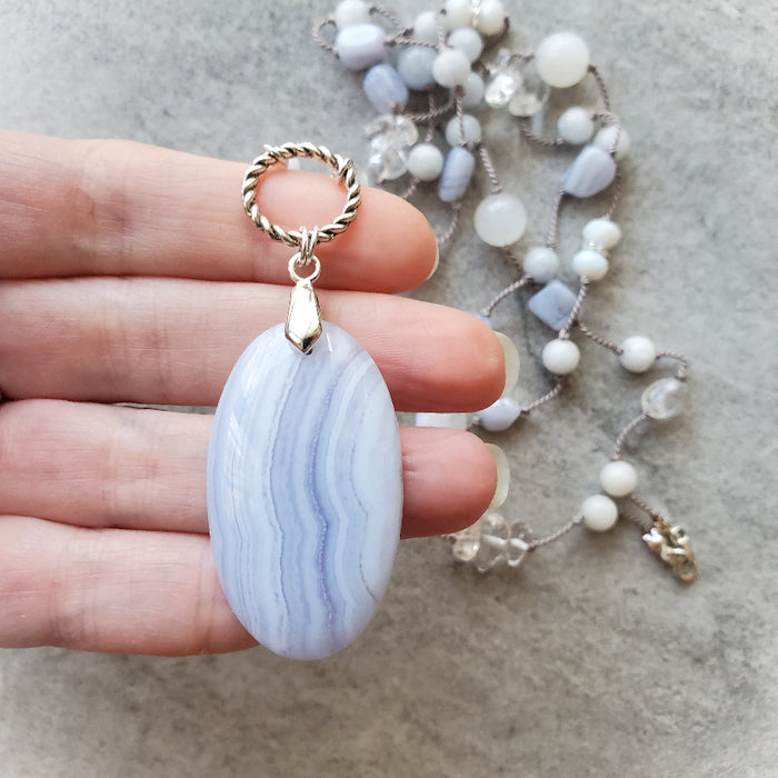 Multi Gemstone long knotted necklace in hand