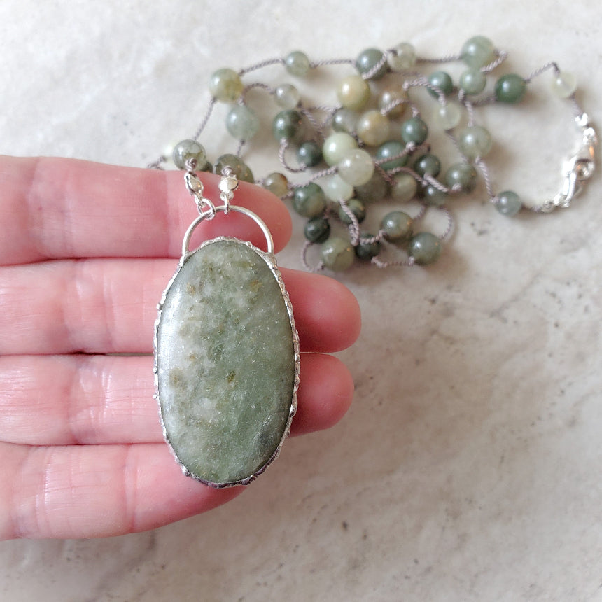 Beaded gemstone necklace in hand