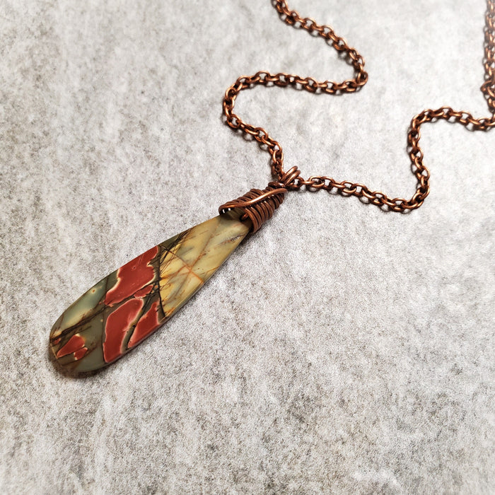 Picasso Jasper teardrop pendant necklace on tile