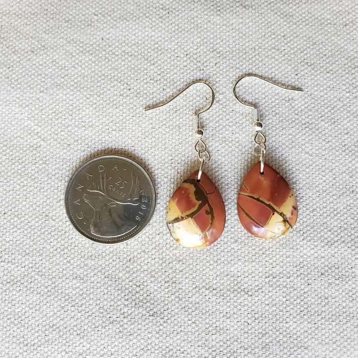 Picasso Jasper teardrop earrings beside a quarter