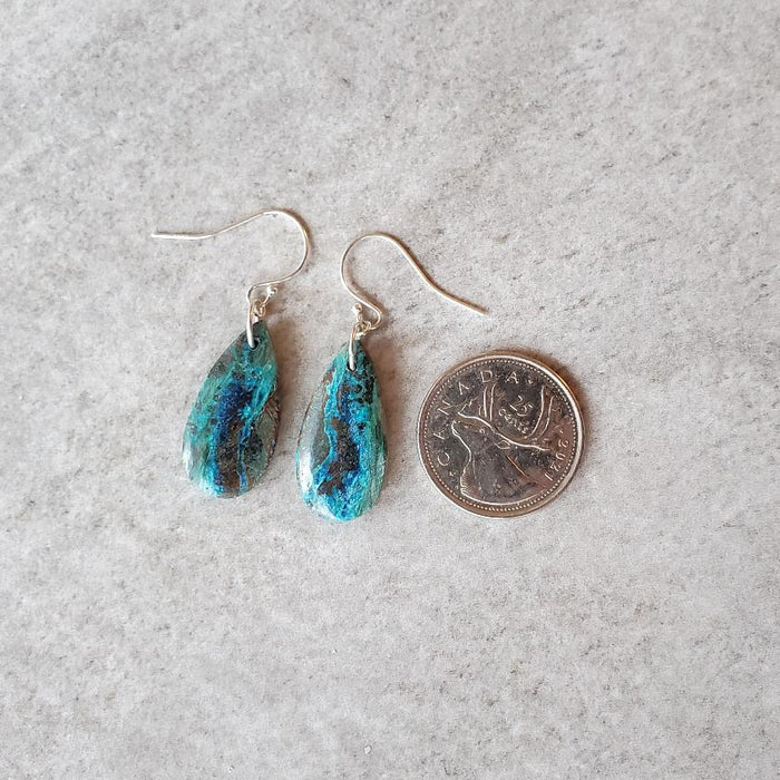 Chrysocolla teardrop sterling silver earrings beside a quarter