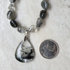 Rutilated Quartz chunky necklace beside a quarter