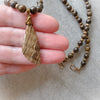 Bronzite and Aragonite chunky necklace in hand