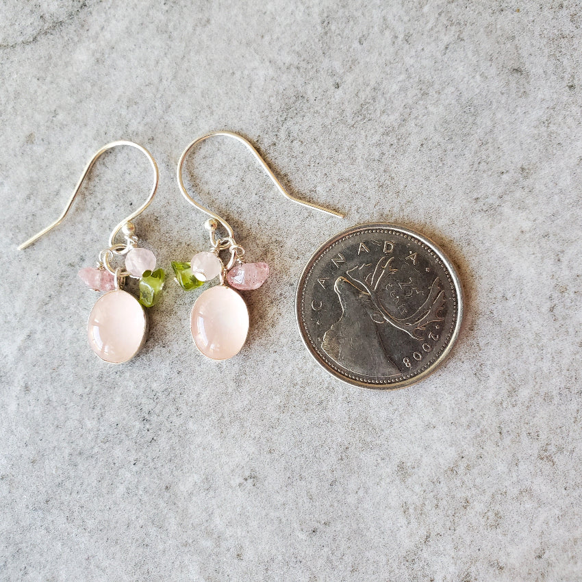 Rose Quartz Cluster Dangle earrings beside a quarter