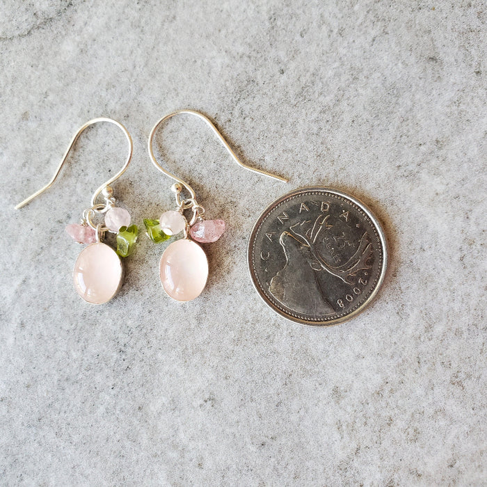 Rose Quartz Cluster Dangle earrings beside a quarter