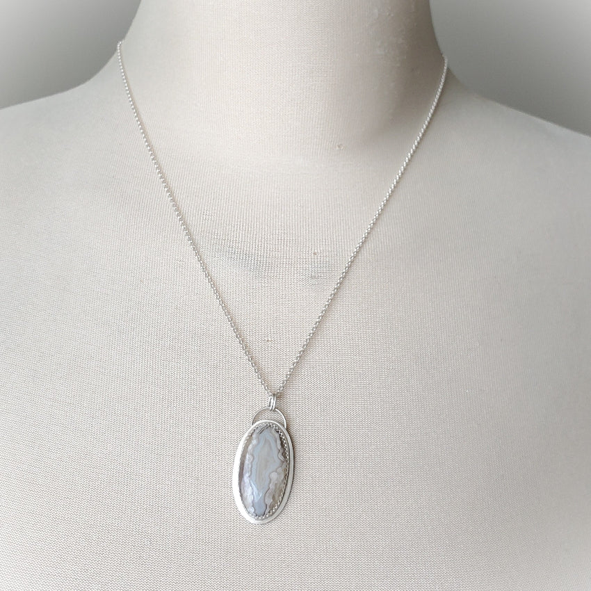 Crazy Lace Agate silversmith pendant on bust