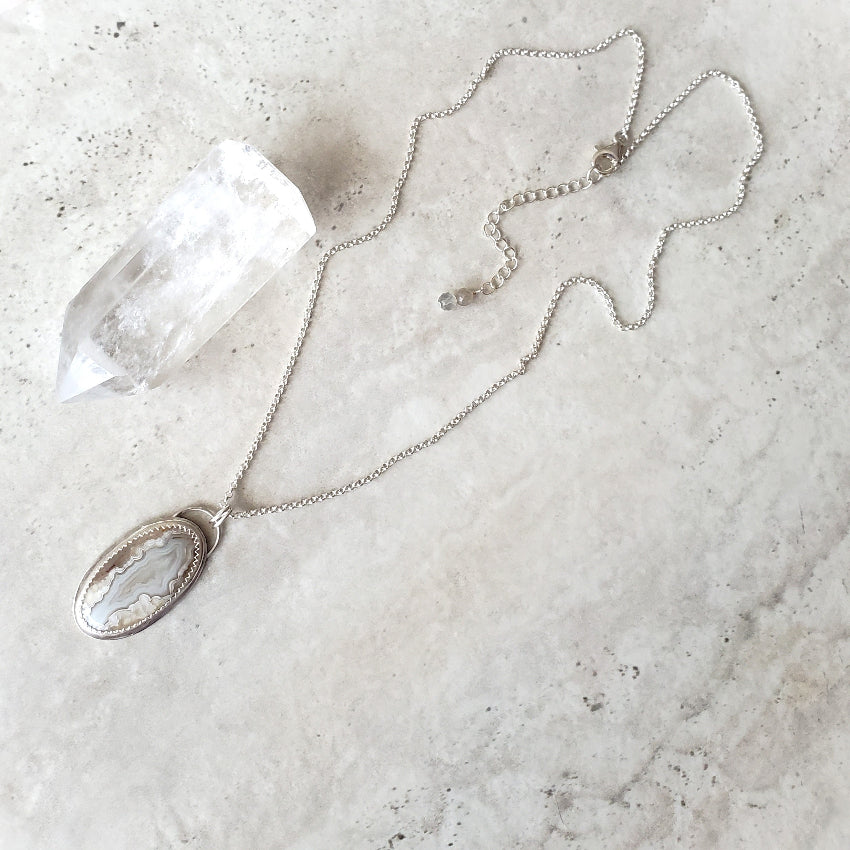 Crazy Lace Agate silversmith pendant on tile