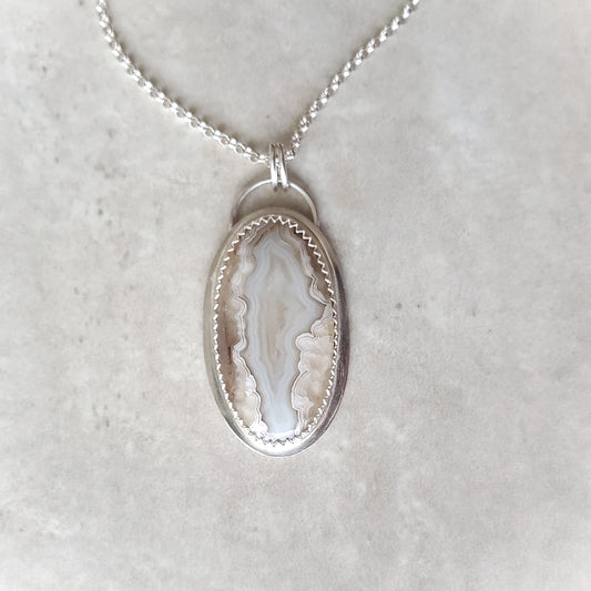 Crazy Lace Agate silversmith pendant on tile