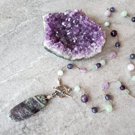 Purple and Green gemstone knotted necklace on tile