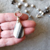 long Zebra Calcite hand knotted beaded necklace in hand
