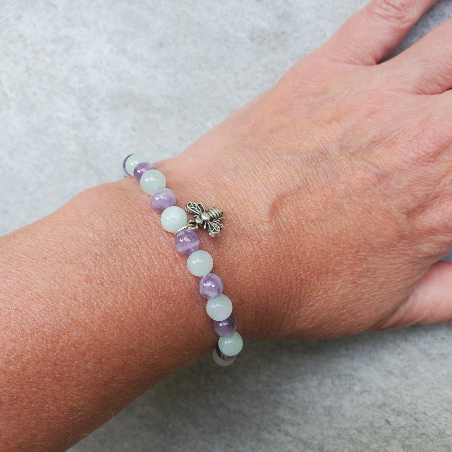 Amethyst Burma jade stretch bracelet with bee charm  on model