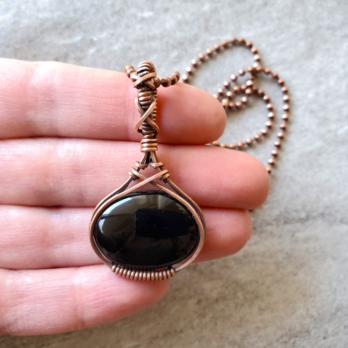 black onyx wire wrap pendant in hand