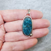Blue Apatite oval silversmith pendant in hand