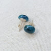 Oval Blue Apatite stud earrings on linen