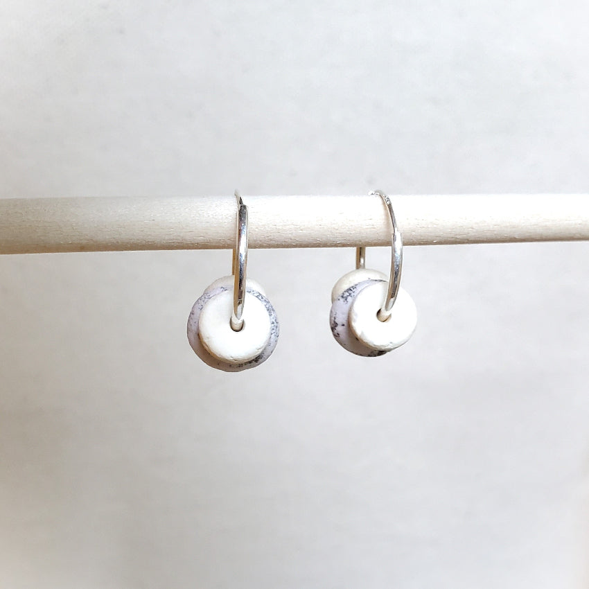 Pair of silver earrings on a white background