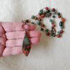 Hand knotted Jasper and Moss Agate necklace in hand