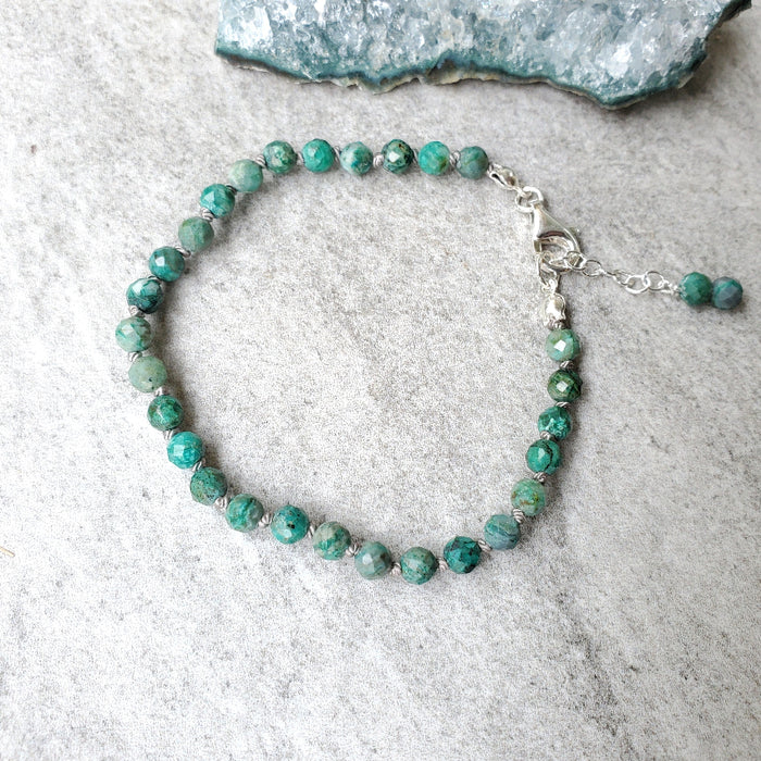 Faceted Chrysocolla knotted bracelet on tile