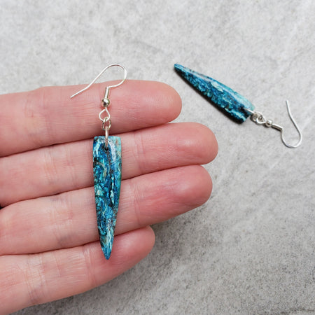 Chrysocolla tooth shape earrings in hand