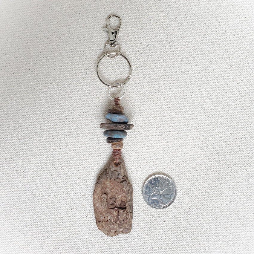 Keychain with natural wood components on a light fabric background