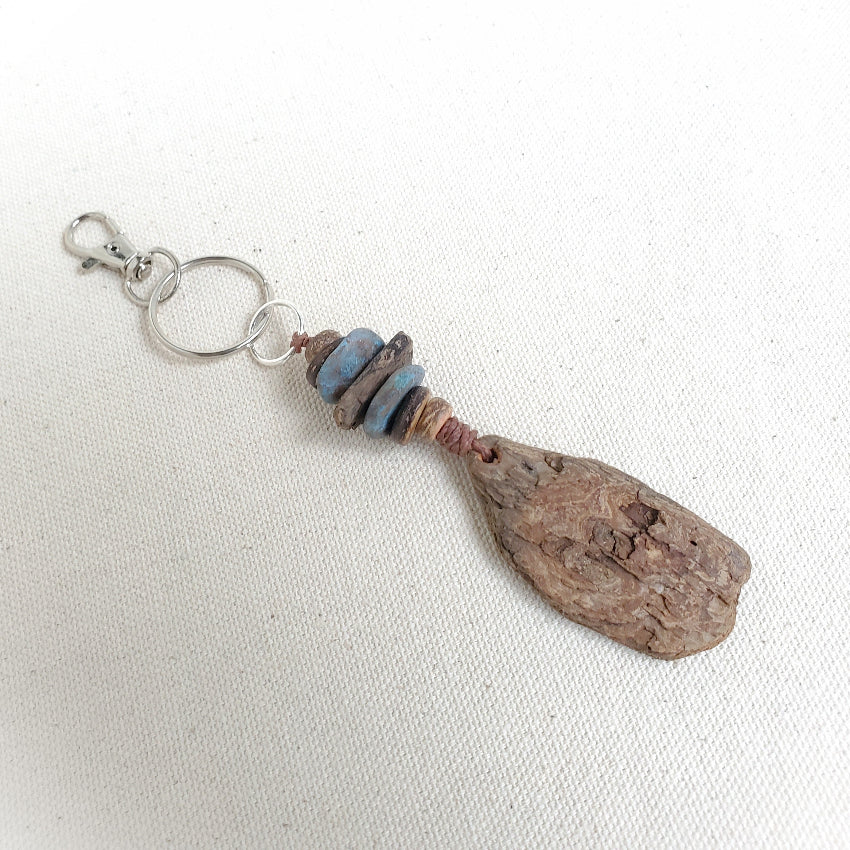 Driftwood keychain with beads on a white background