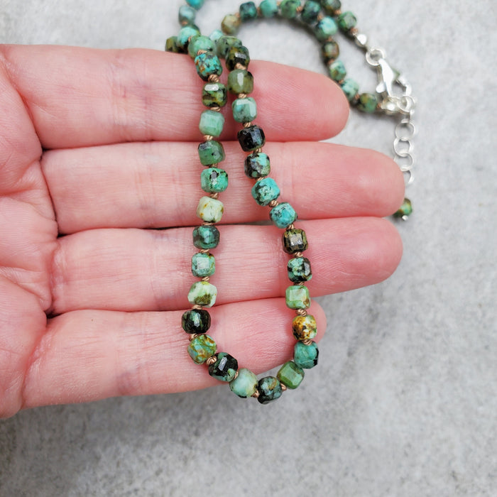 Faceted 4mm cube African Turquoise necklace in hand