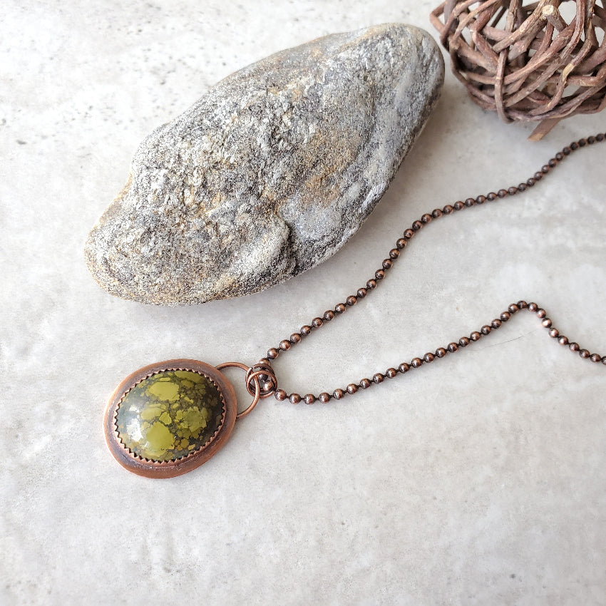 Tibetan Turquoise metalsmith necklace on tile