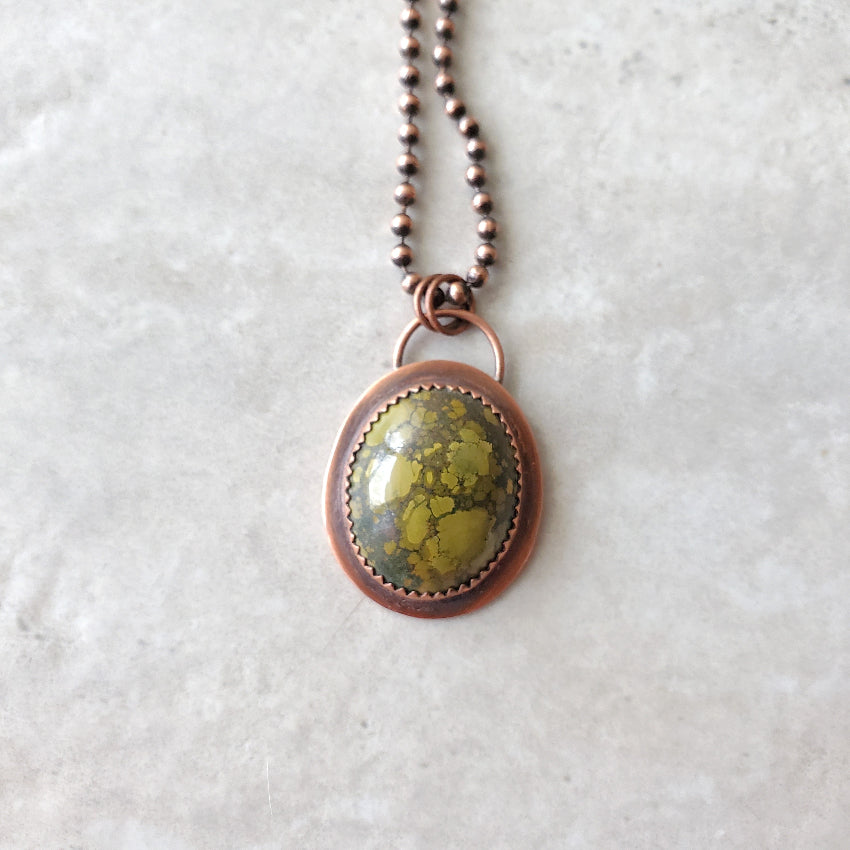 Tibetan Turquoise metalsmith necklace on tile 