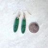 African Jade gemstones on sterling silver ear wires beside a quarter