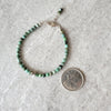 Faceted African Turquoise bracelet beside a quarter